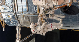 Astronauts repairing the Hubble Space Telescope