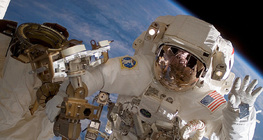 An astronaut assembling the International Space Station