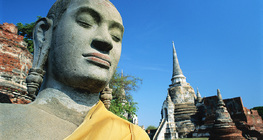 Buddha-Statue mit einem Tempel im Hintergrund