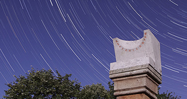 Star trails and a meteor over an ancient sundial